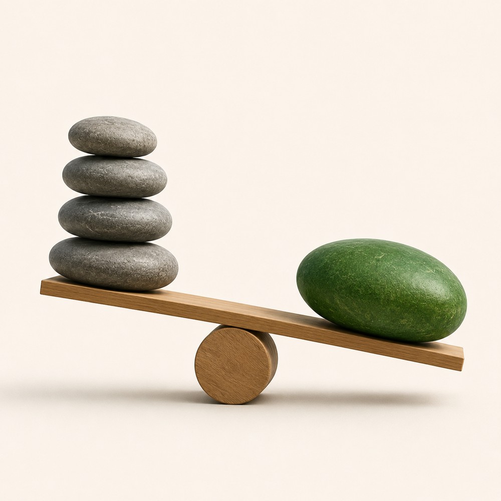 One green stone outweighs a stack of four grey stones